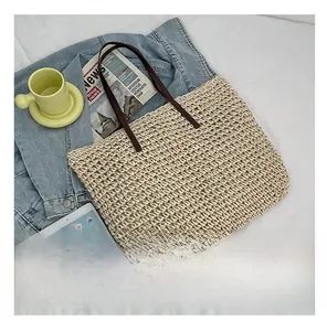 Woven straw tote bag with leather straps showing large capacity compared to an iPad