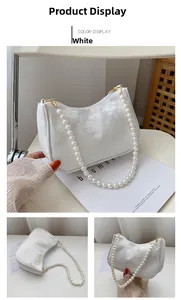 Detail of white lace texture armpit bag with large elegant pearl shoulder strap