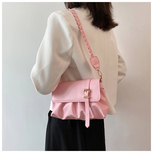 Pink pleated crossbody bag featuring woven leather strap and metal buckle detail