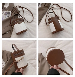 Detailansicht der Zylindertasche mit brauner Krokoprägung und Goldbeschlägen