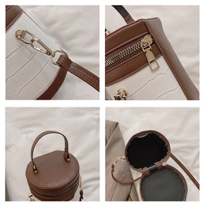 Detailansicht der Zylindertasche mit Goldbeschlägen, Strukturnähten und Innenraum