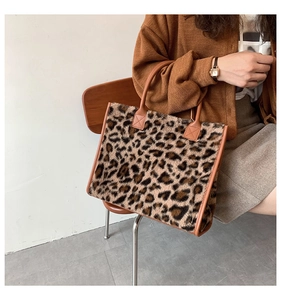 Dettaglio borsa tote leopardata in ecopelliccia con manici in pelle marrone caldo