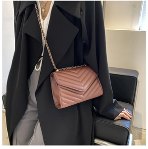 Quilted crossbody bag with chain strap shown on model for size and style reference