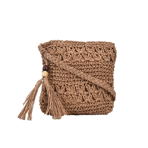 Minimalist hand-woven khaki straw crossbody bag with hollow floral pattern and tassel charm