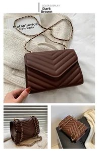Close-up of dark brown quilted leather handbag with gold chain strap and V-pattern stitching