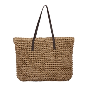 Handwoven straw tote bag with honeycomb hollow design and dark brown leather shoulder straps