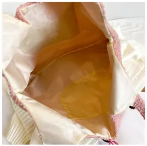 Détails de l'intérieur du sac en peluche rose avec doublure et poche interne