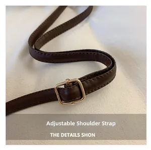 Macro shot of adjustable leopard bucket bag shoulder strap with gold metal buckle
