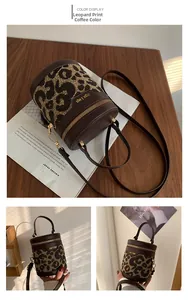 Detail of leopard print coffee bucket bag with leather trim and gold zipper