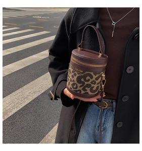 Close-up of leopard print bucket bag with high-quality faux leather and gold hardware