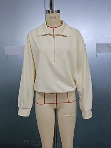 Detail of off-white half-zip pullover sweatshirt with polo collar and ribbed cuffs