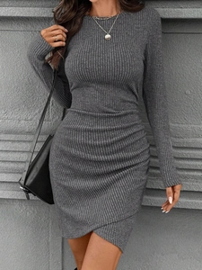 Detail of gray ribbed knit dress featuring slim fit cut and asymmetrical crossover hemline
