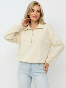 Women's cream oversized half-zip polo sweatshirt with ribbed cuffs and metal zipper detail