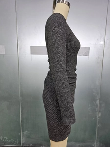 Detail of grey knitted long sleeve dress featuring vertical ribbed texture and slim fit