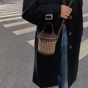 Vintage burgundy leather and houndstooth bucket bag with adjustable shoulder strap