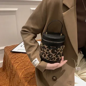 Trendy leopard print bucket bag with leather trim and gold zippers for autumn fashion