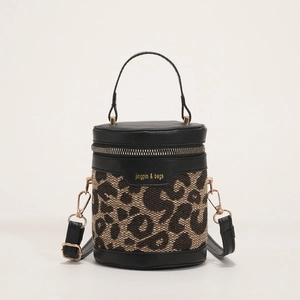 Leopard print bucket bag with black leather trim and golden zipper on white background