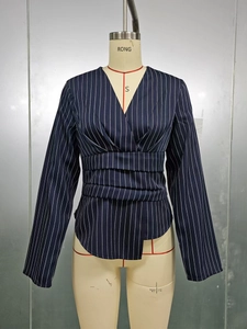 Detail of navy blue striped V-neck blouse with waist pleats and wrap design on mannequin