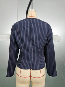 Detail view of navy pinstripe blazer back featuring a functional zipper at the bottom hem