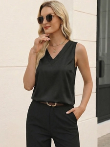 Detail of silk-like satin fabric texture and V-neckline on women's sleeveless black top