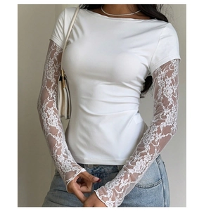 Close-up of elegant white lace splicing and floral sleeve texture on a slim-fit top