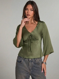 Elegant olive green satin V-neck blouse with lace-up detail and flared long sleeves