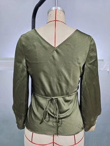 Olive green long sleeve shirt with diagonal texture, back V-neck, and adjustable waist tie