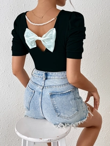 Slim-fit black short sleeve tee with green bow and pearl trim, open back view for women