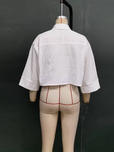 Detail view of the back yoke and half-sleeve design on white cotton crop shirt