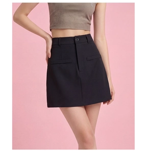 Close-up of black A-line mini skirt with decorative pockets and single button waist detail