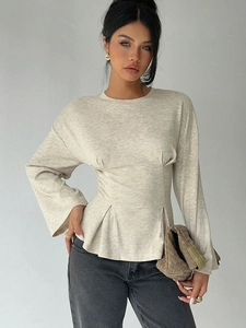 Minimalist oatmeal long sleeve knit top with flared sleeves and pleated waist details
