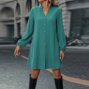 Teal long sleeve A-line dress with V-neck and button front detail in city street setting