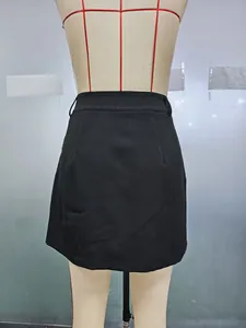 Detail view showing smooth back waistband and darts on black A-line mini skirt
