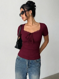 Detail of burgundy lace trim square neckline and drawstring bow on slim fit ribbed top