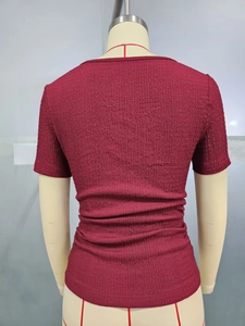 Slim fit burgundy short sleeve top showing textured fabric and tailored back seam detail