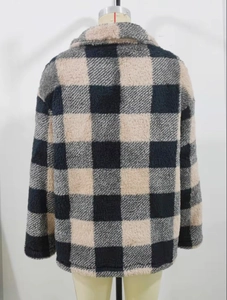 Detail view of a thick black and beige checkered fleece jacket on a mannequin