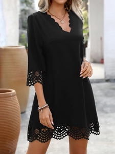 Close-up of elegant V-neckline with scalloped edges and intricate hollow floral patterns