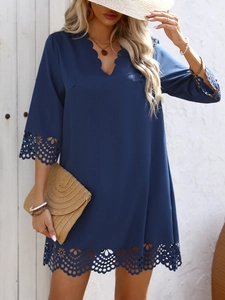 Navy blue V-neck dress with laser-cut floral details and scalloped hem for vacation