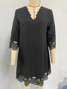 Detail of V-neck scallop edge and floral laser-cut hollow pattern on black dress