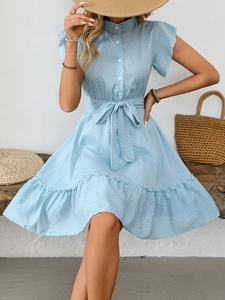 Détail de la robe bleu clair à pois avec manches volantées et ceinture assortie nouée