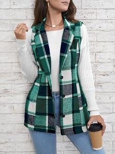 Detail shot of green and white plaid vest fabric with classic buttons and notch lapels
