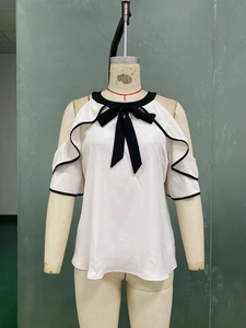 Detail of cold shoulder design and black ribbon bow on white double-layer chiffon shirt