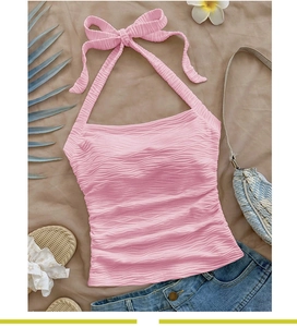 Pink halter top with pleated texture and bow tie neck for summer beach vacation style