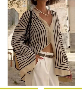 Detail of French style striped long sleeve shirt with vertical and horizontal patterns