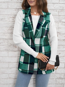 Detail of green and white plaid vest with lapel collar styled with striped long sleeve shirt