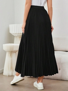Elegant black pleated maxi skirt with elastic high waist and sophisticated flowy silhouette