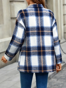 Detail of oversized plaid shacket for women featuring classic check pattern in a street view