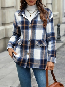 Detail of blue and brown plaid flannel shirt jacket with front flap pockets and buttons