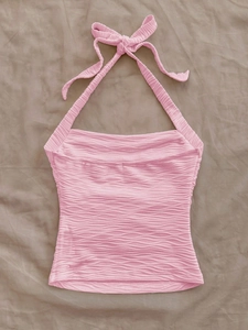 Pink halter neck crop top with wavy knit texture for beach vacation style