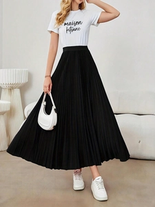 Elegant high-waisted black pleated maxi skirt with a long flowy A-line silhouette